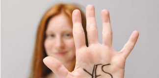 woman holding up hand saying yes