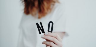 Woman holding letters N O