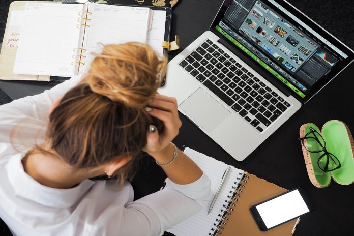 stressed lady with hands in head working