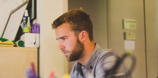 man concentrating on work at laptop