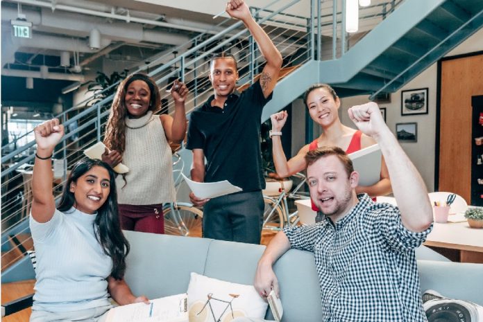 group of pumped up and motivated people in office