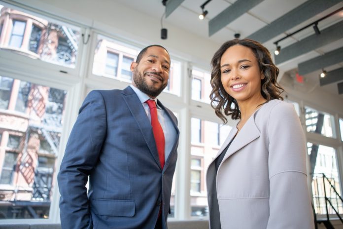 woman and man dressed in impressive suits