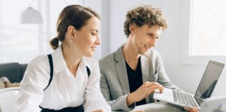 Intern with employee in office