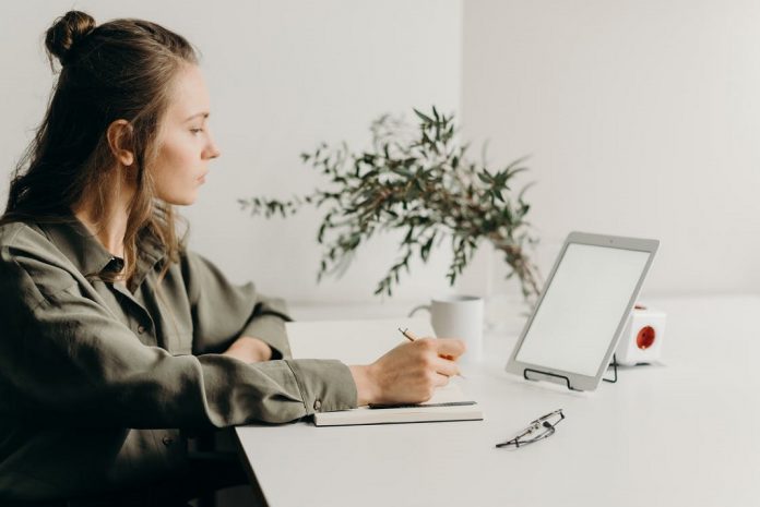woman working from home sitting at laptop