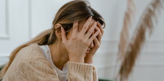 distressed woman with head in hands