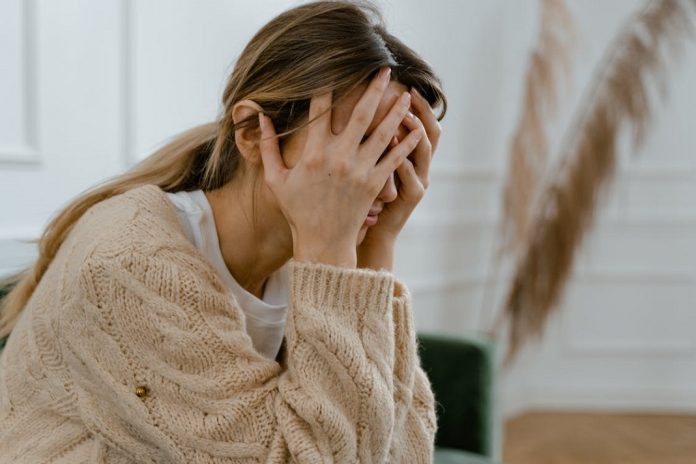distressed woman with head in hands