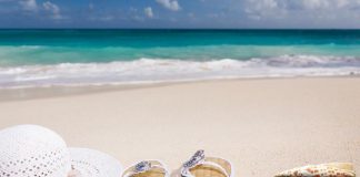 hat and shoes on sunny beach