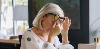 woman in front of laptop rubbing sore eyes