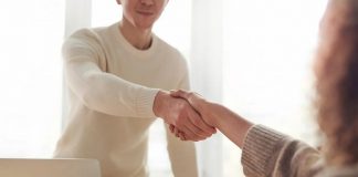 people shaking hands in office