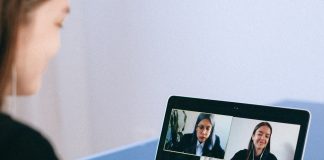 person taking part in online group call on laptop