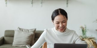 lady on laptop taking notes on conference call