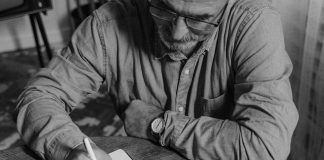 Man Writing in notebook