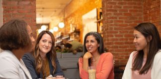 group of woment sitting around a table chatting