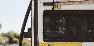 old battered whie and yellow fuel pump gauge