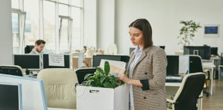 dark haired lady packing her office belongings into a box